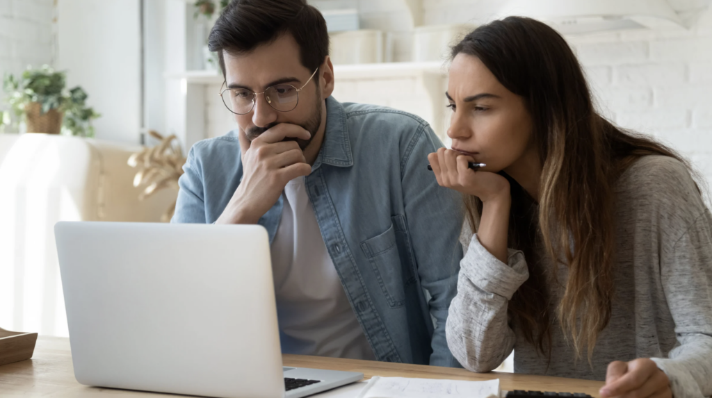 Couple reviewing information on a laptop, contemplating legal processes related to will legalization in Texas.